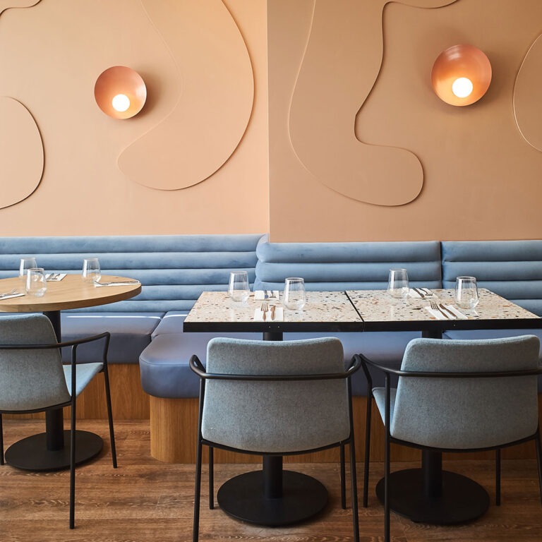 Shelly Iceblast leather banquette seating along a pink wall at Bocca Bocca 