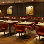 Red buttoned leather banquettes and leather dining chairs at 100 Wardour Street