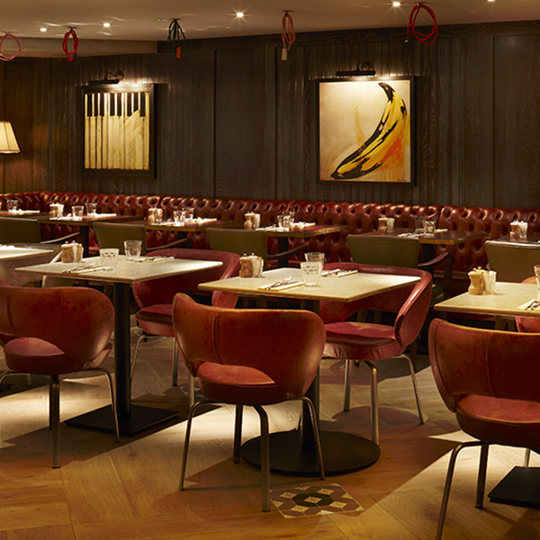 Red buttoned leather banquettes and leather dining chairs at 100 Wardour Street