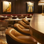 Tan leather bar seats along the counter at 100 Wardour Street