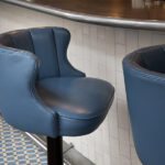 Blue leather bar stool at the counter of 28°-50° Wine Workshop & Kitchen
