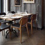 Dining tables with leather-seated chairs at 28°-50° Wine Workshop & Kitchen