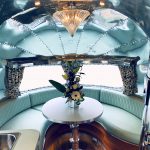 Curved Vele Jade Green leather seating around a table in an Airstream caravan