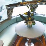 Vele Jade Green leather seating and round table in an Airstream caravan