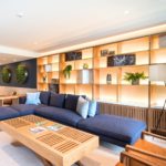 Lounge with a blue sofa and Old English Bruciato leather armchairs at Chelsea Crescent 
