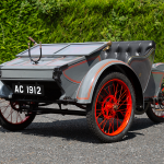 Rear view of the restored 1903 AC Sociable showing its black leather seat