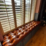 Old English Malt leather window seat in sunlight