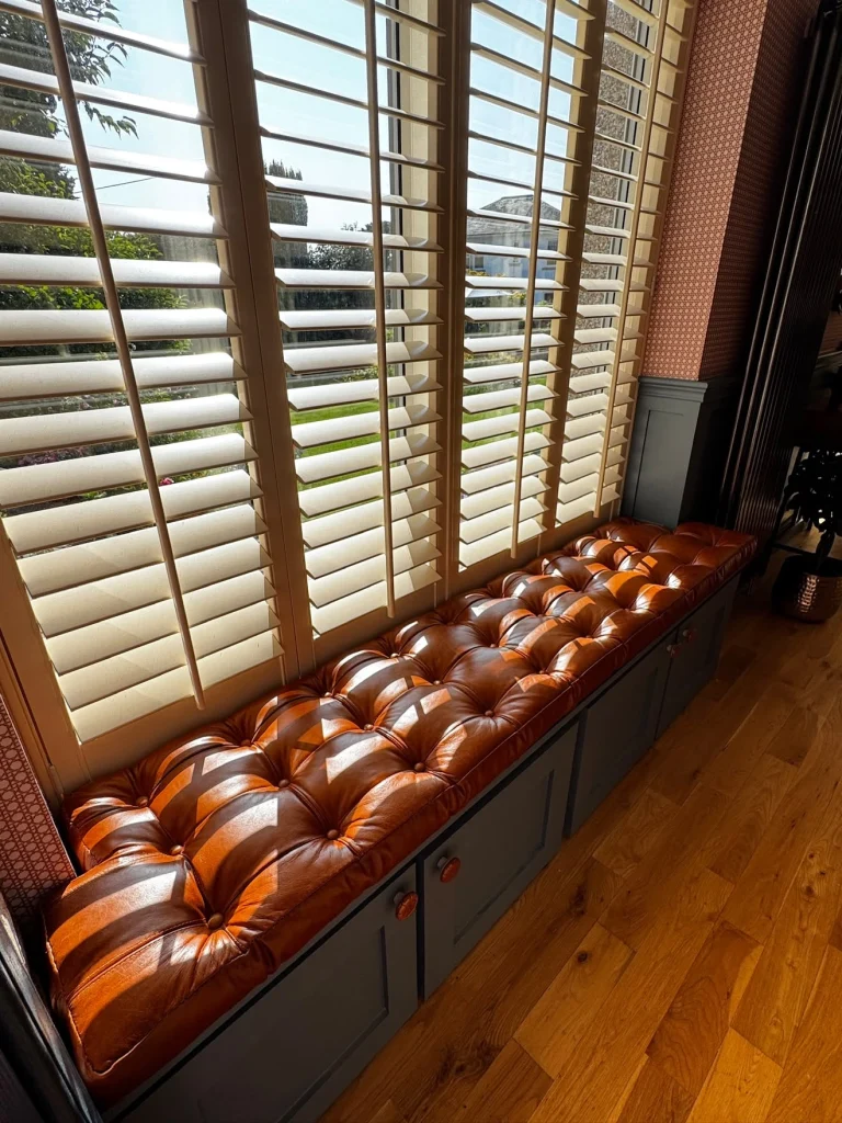 Old English Malt leather window seat in sunlight
