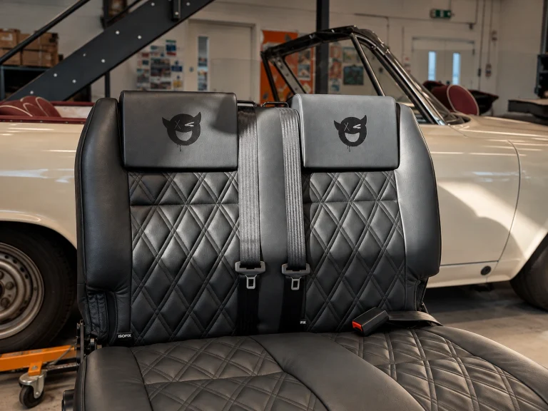 Black leather bench seat with diamond quilting by Trimatt Ltd.